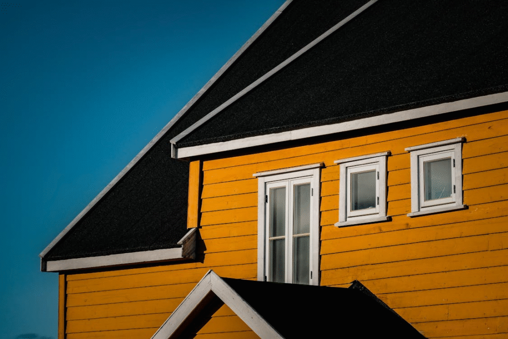 A yellow house against a blue sky
