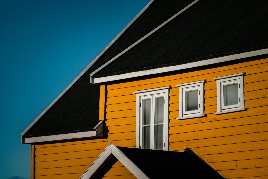 A yellow house against a blue sky